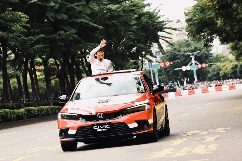 F1日籍賽車手角田裕毅乘車遊行賽道一圈，與夾道爆滿的六萬名觀眾的熱烈互動。 圖／Red Bull提供