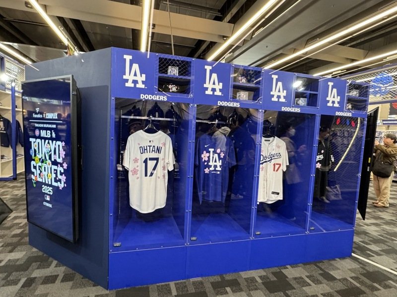 迎美國職棒大聯盟（MLB）東京海外開幕戰，官方周邊商品店販售的項目眾多，除了球衣、T恤、棒球帽、「村上隆×MLB限定商品」，各種馬克杯、保溫杯、應援棒、應援扇，甚至還有兒童球衣、扭蛋等，令人眼花撩亂。中央社記者楊明珠東京攝  114年3月14日 中央通訊社